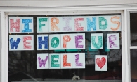 Hopeful covid sign hanging in window