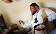 Michael Twitty cooks food at Fort Snelling.