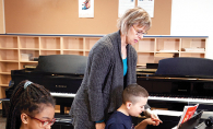 Two children take piano lessons through a partnership with the MacPhail Center for Music.