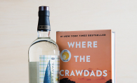 A bottle of Tattersall Bootlegger, a spirit featuring distilled lime and lemon peels, sits next to "Where the Crawdads Sing" by Delia Owens.