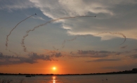 Planes flying over the lake at sunset