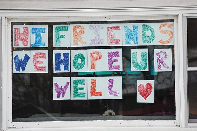 Hopeful covid sign hanging in window