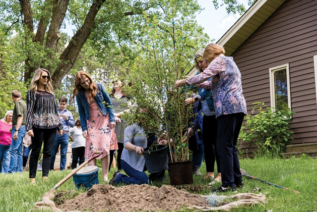 Leadership Tomorrow volunteers planting trees at Katherine Abbott Park.