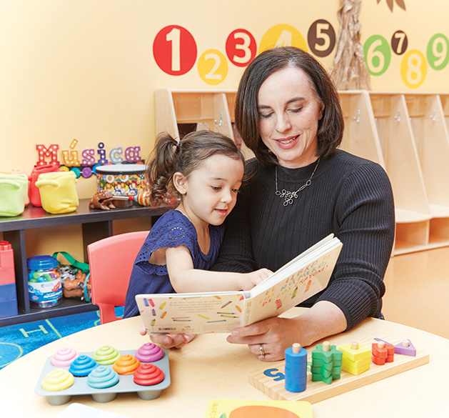 Bilingual Child Care & Education Center Leah Retamozo reads to a child at Bilingual Child Care & Education Center.