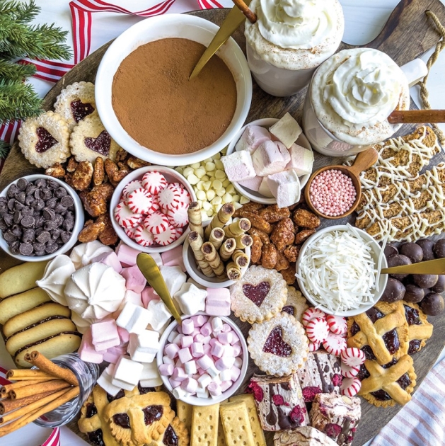 A hot chocolate board with many sweet treats.