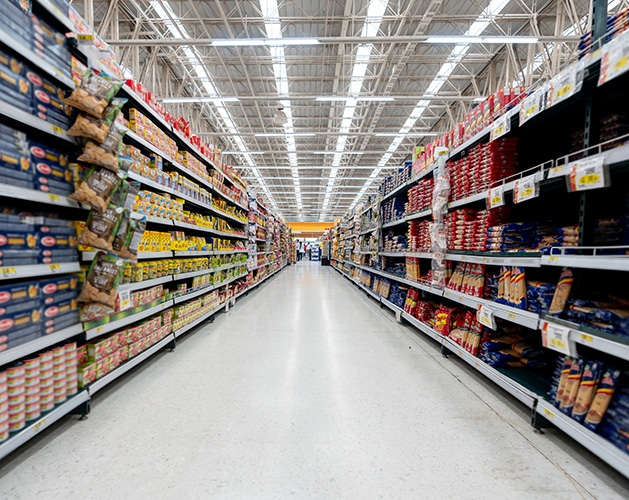 The aisles of a grocery store, shelves stocked with food