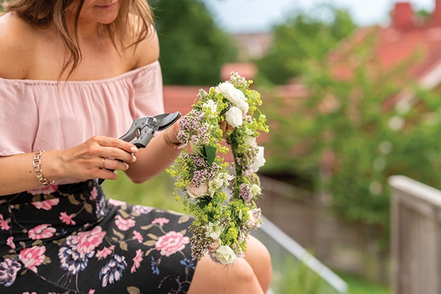 A woman makes a flower crown.