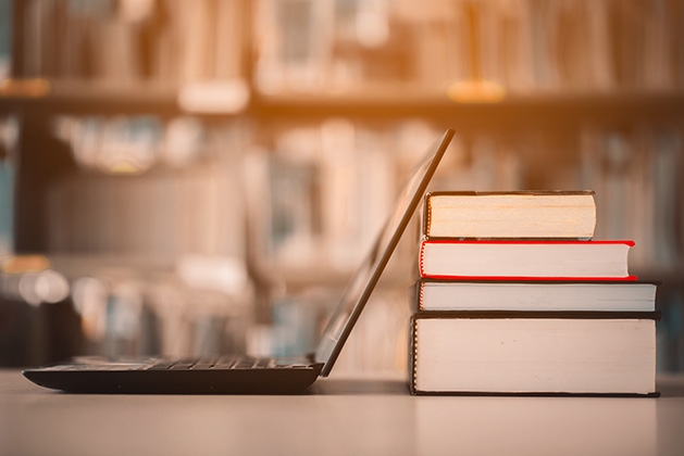 A laptop donated to the White Bear Lake Rotary Club Technology Drive rests against some books.