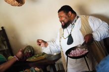 Michael Twitty cooks food at Fort Snelling.