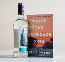 A bottle of Tattersall Bootlegger, a spirit featuring distilled lime and lemon peels, sits next to "Where the Crawdads Sing" by Delia Owens.