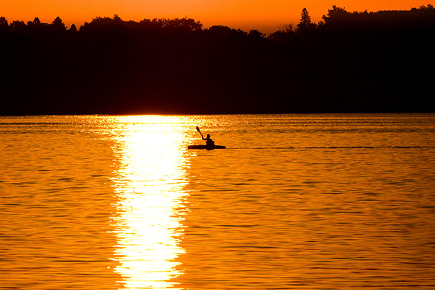 A kayaker paddles on White Bear Lake