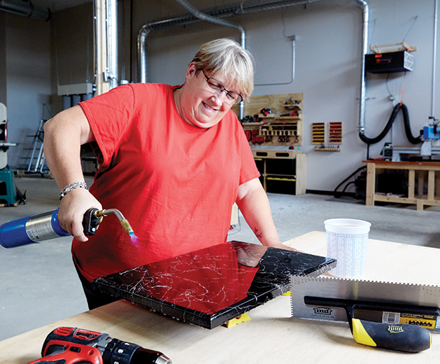 Theresa Lendman works on a woodworking project at the White Bear Makerspace.